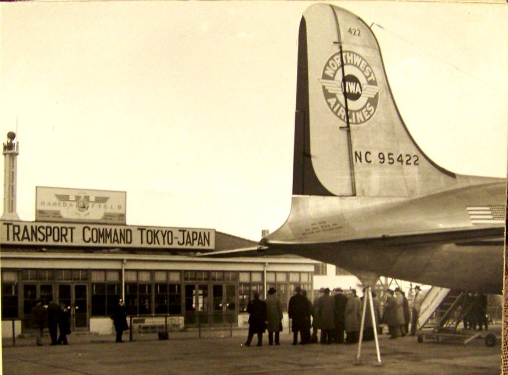 A Northwest DC-4 is posed next to a U.S. military command post at Tokyo's Haneda Airport in 1947. One of the videos we offer for sale is a recollection from NWA staff who pioneered early flights to East Asia.